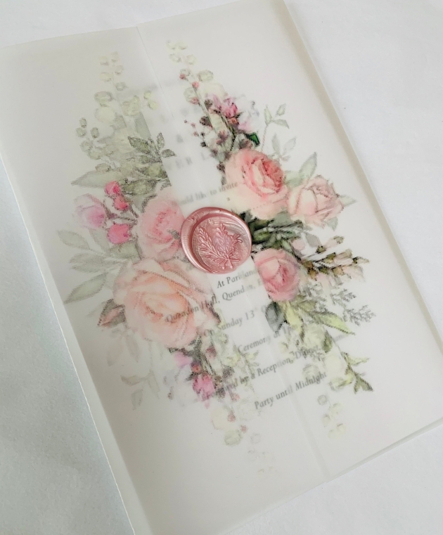 Handcrafted wedding stationery on white with floral decorations