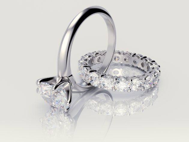 Two silver-coloured wedding rings inset with diamonds