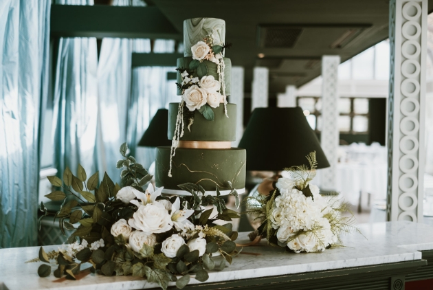 green marble iced wedding cake decorated with white flowers