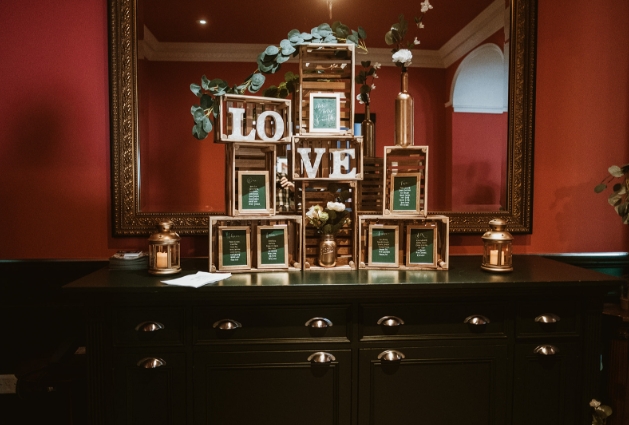 wedding decor of crates and love sign complete with framed table plan