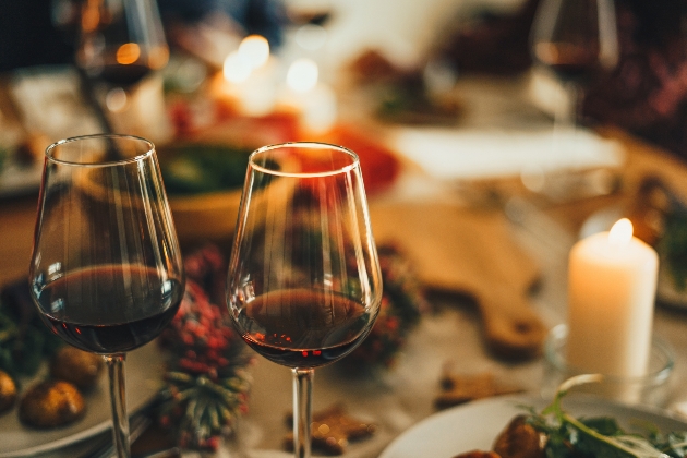 Two glasses of red wine on a Christmas table. 