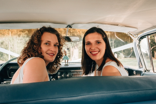 2 of Harps Adele and Karina in front seat of wedding car