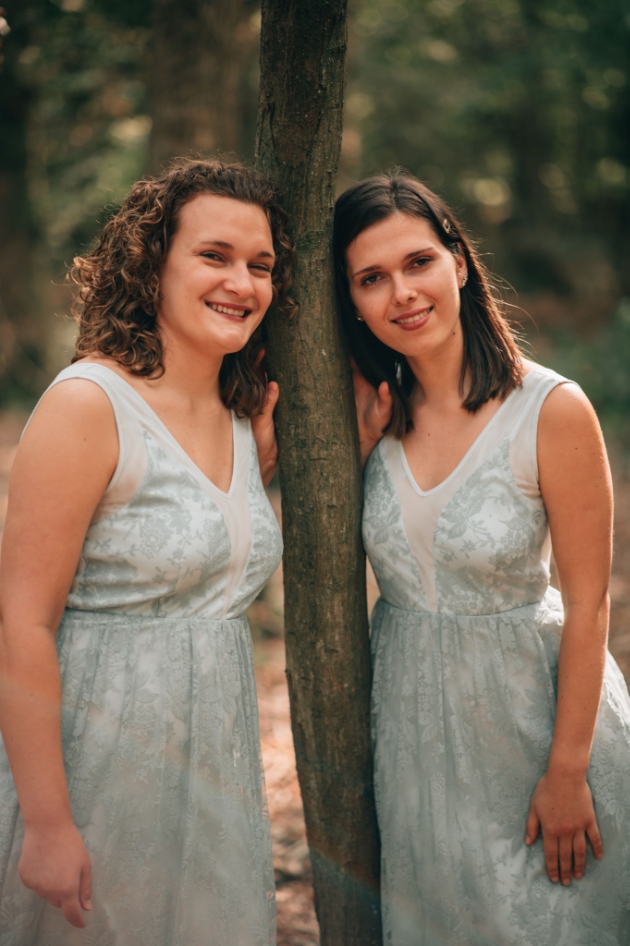 2 of Harps' Adele and Karina wearing pale blue dresses
