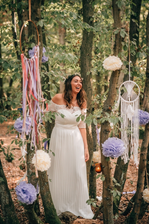 bride laughing amongst tree decorations