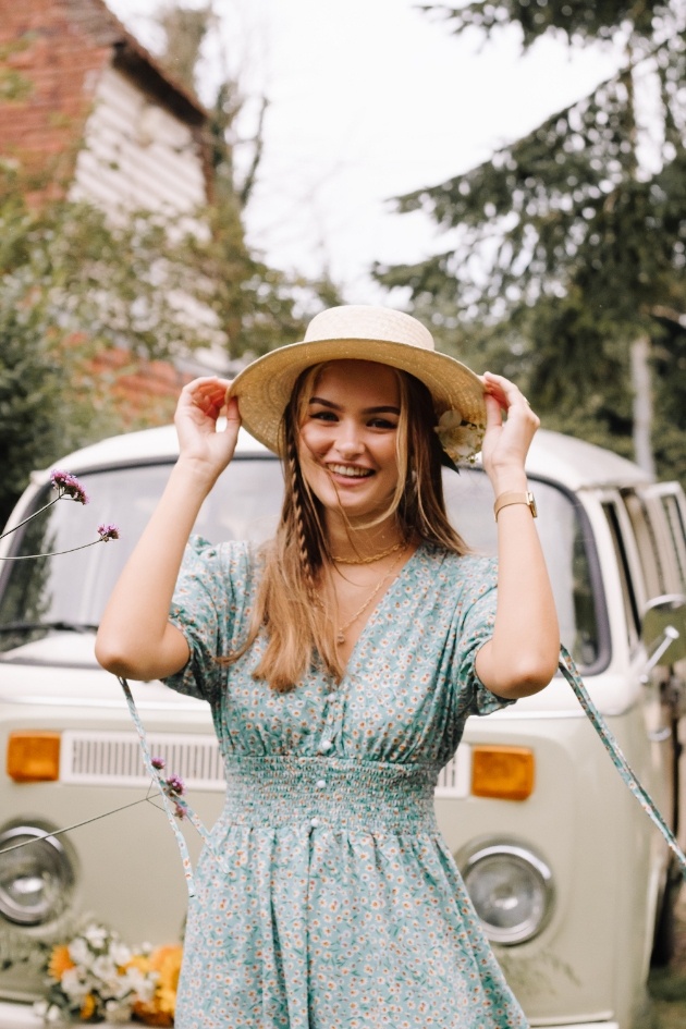 Bridesmaid wearing ditzy print dress and straw boater