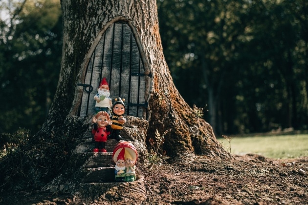 garden gnomes in front of a tree