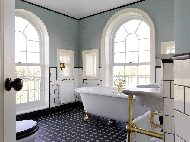 luxury bathroom large window freestanding bath white tiles 