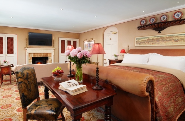 traditional suite with large bed tvs and sofas