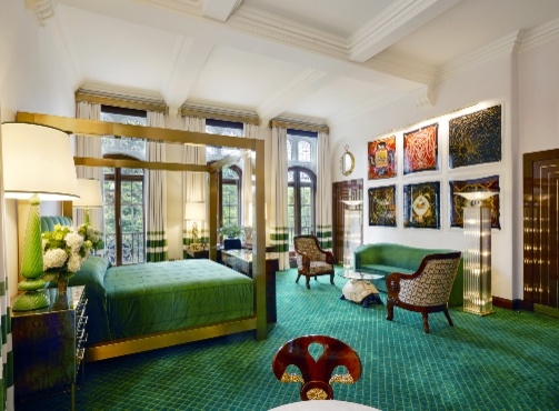 traditional suite with green furnishings and art on the walls