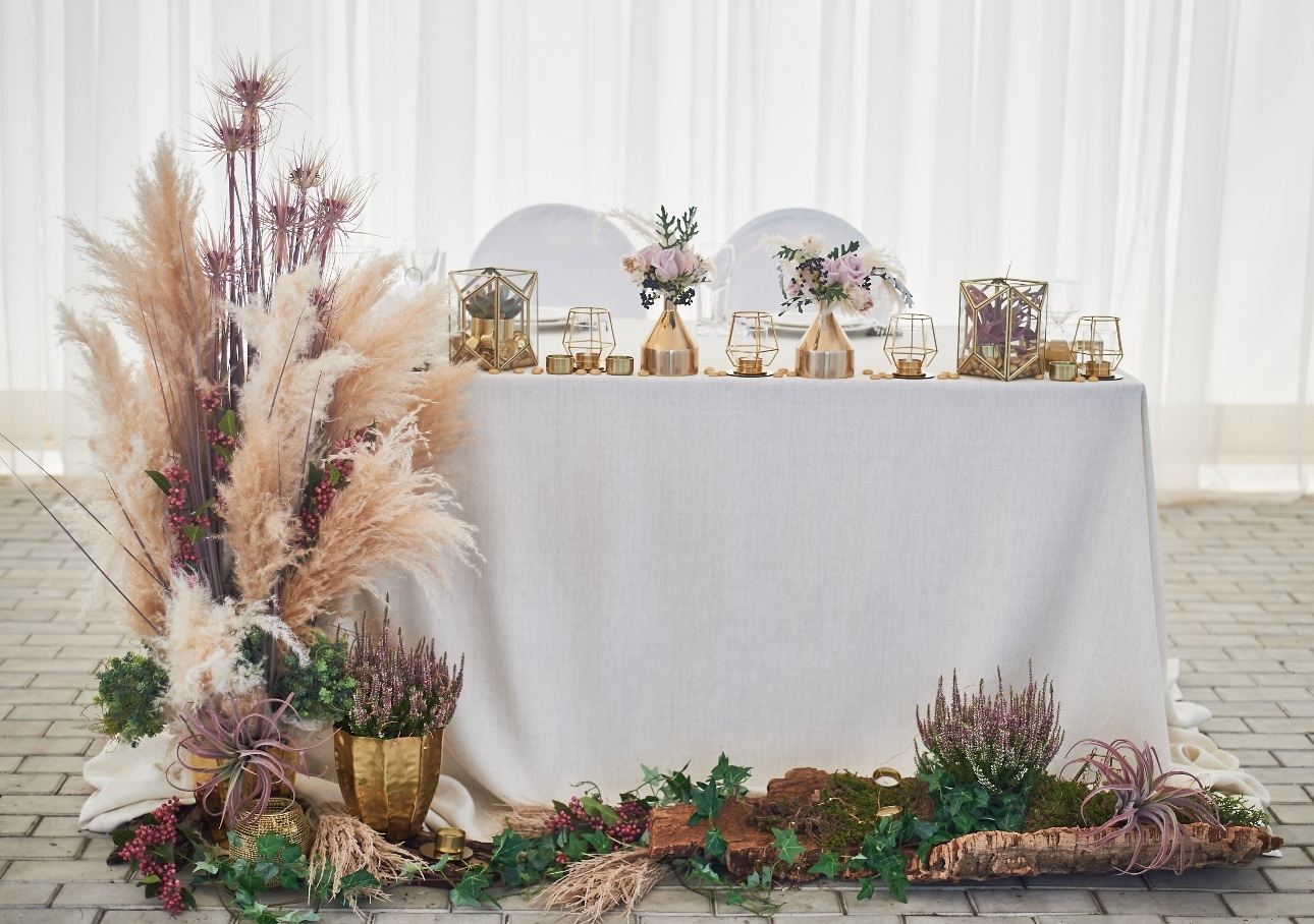 top table set up with pampas grass and succulents and gold decor