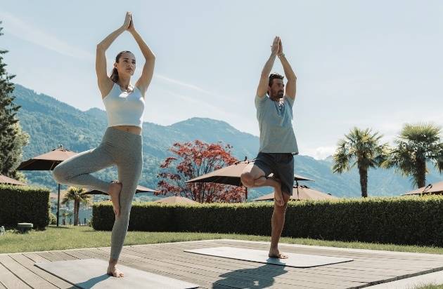 couple in yoga poses outside