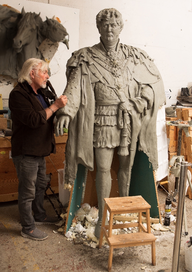 Dominic Grant standing next to King George IV Sculpture