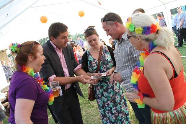 magician with card with group of guests