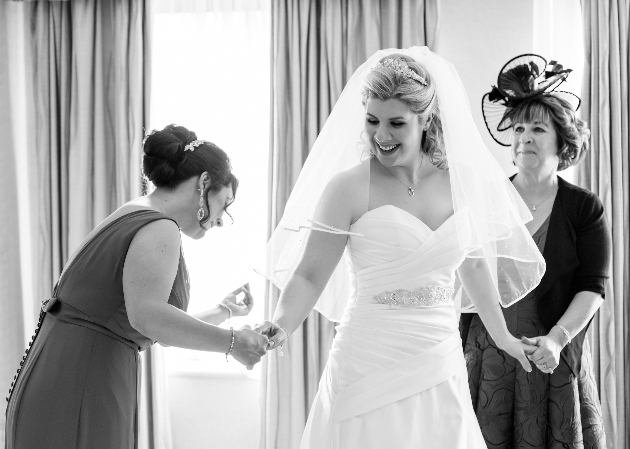 black and white image of bride getting ready on the wedding morning