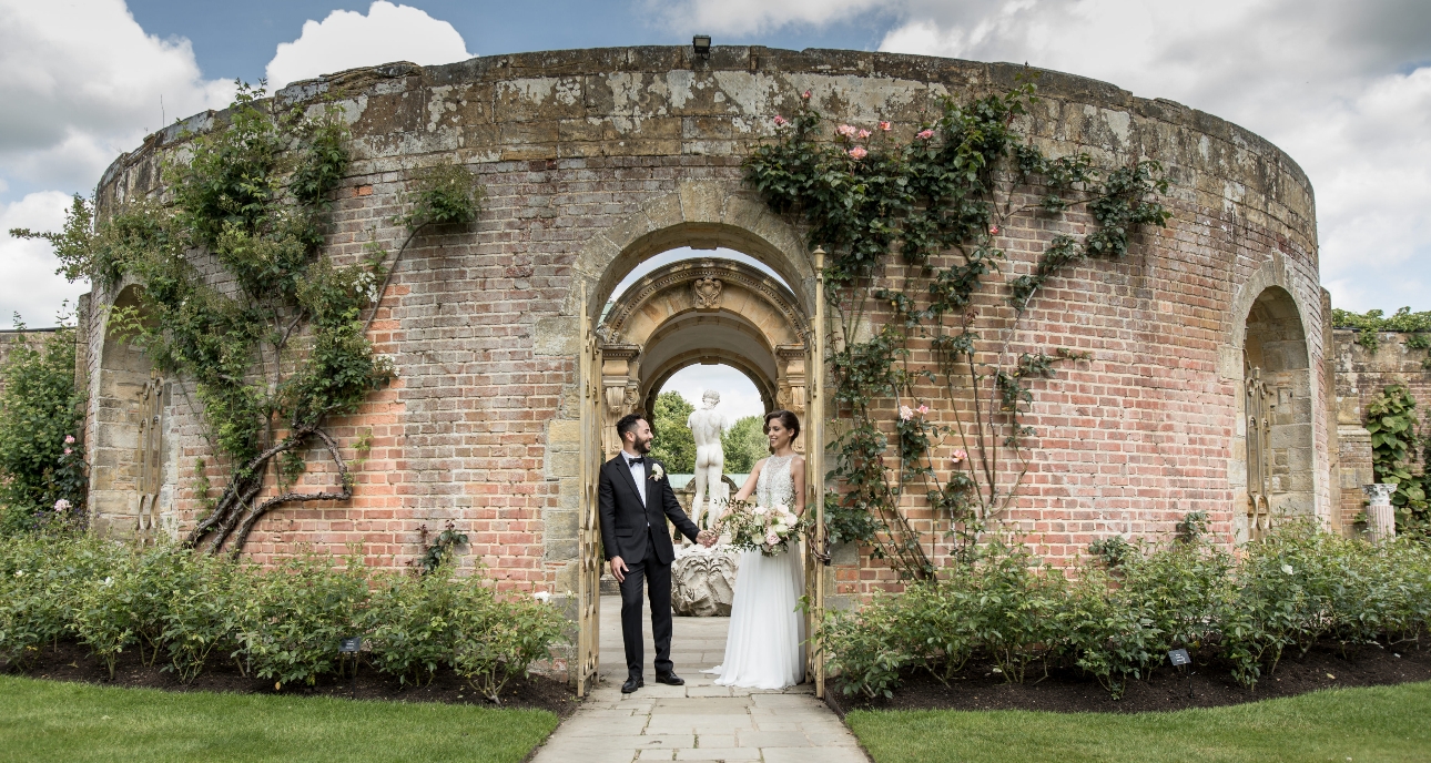 Bride and groom in the italian gardens at hever castle