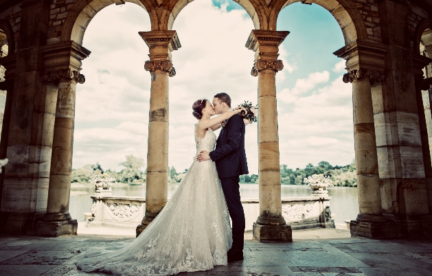 Bride and groom kissing in the Loggia at Hever Castle