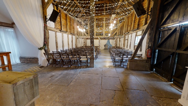 The apple barn at The Barnyard set up for a ceremony with fairylights