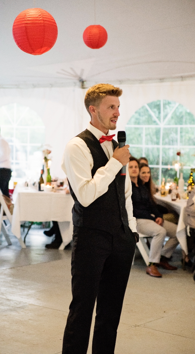 best man talking to wedding guests