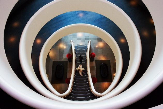 circular rotund stair case bird's eye view with bride walking up the stairs