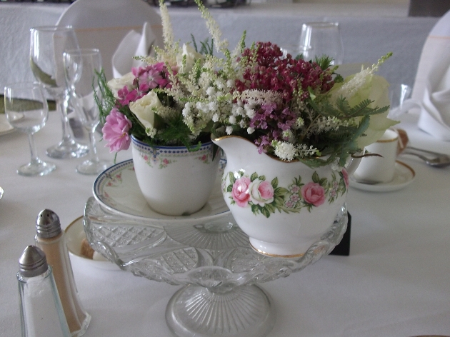 Flowers arranged in a vintage cup and jug