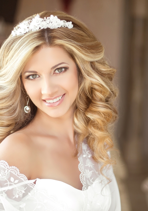 bride with her dress and veil on smiling 