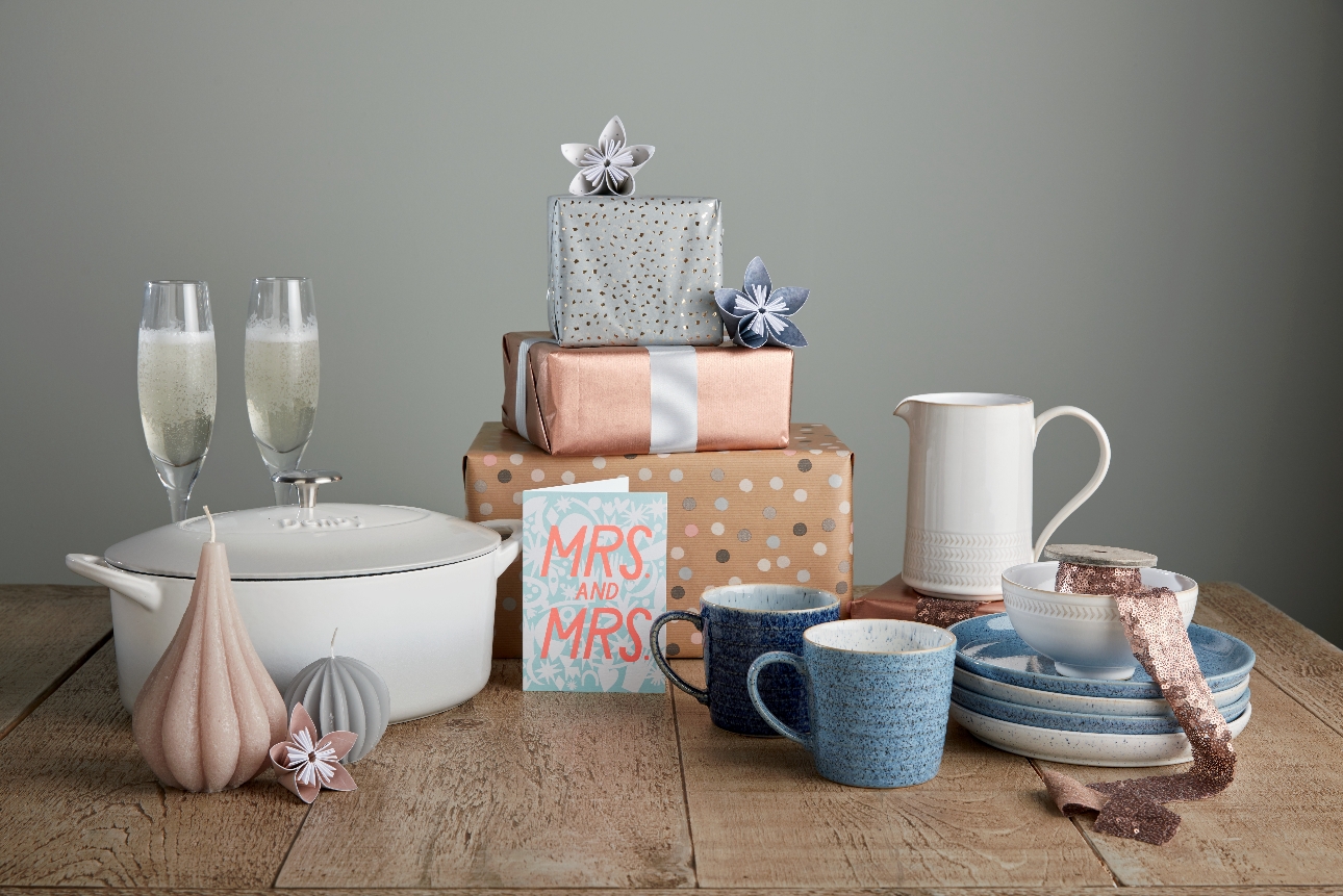 white cooking pot and blue plates and mugs on a gift table