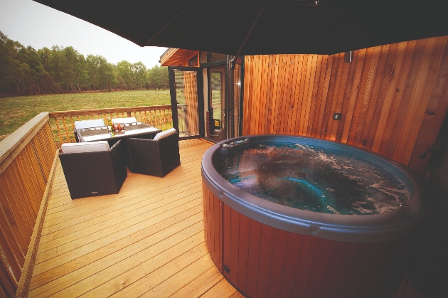 lodge balcony with hot tub and rattan table and chairs