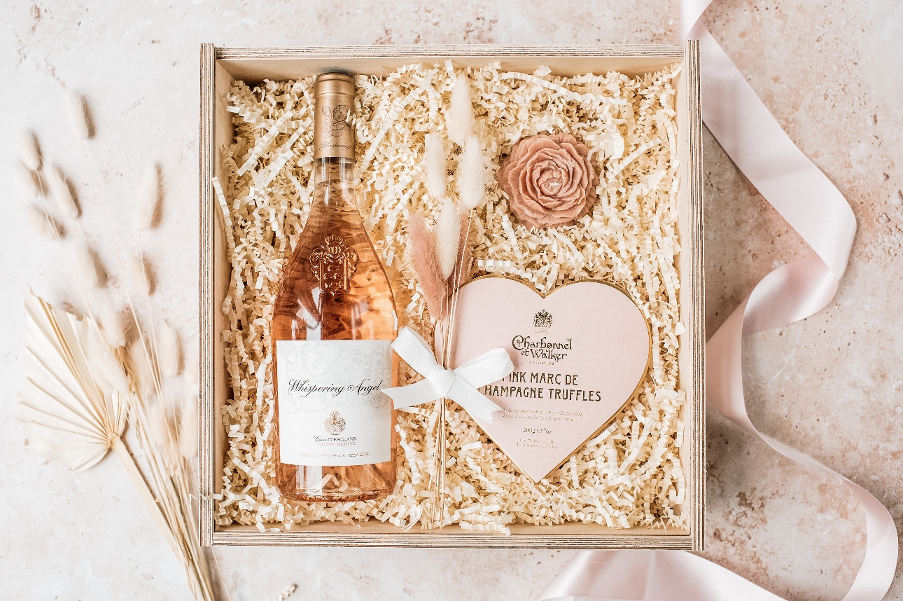open wooden gift box with fizz and chocs inside