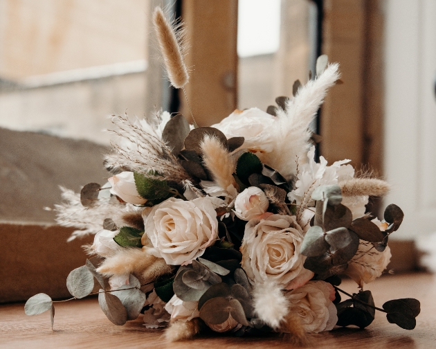 Faux flower bridal bouquet with white, cream, black and foliage