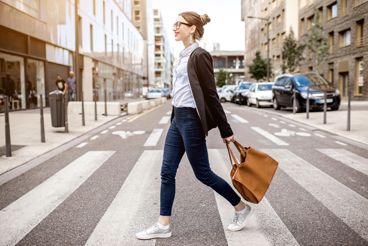 woman walking to work in a busy city