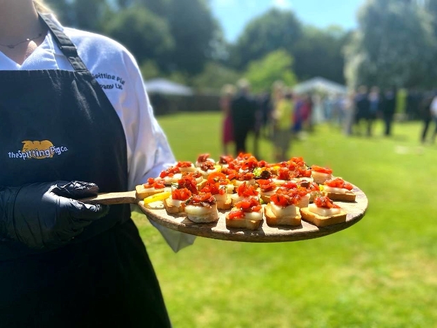 server holding food platter outside