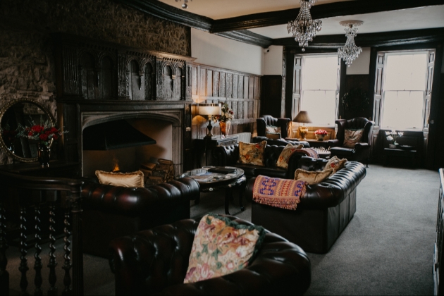 Lounge area with ornate fireplace in stone court house