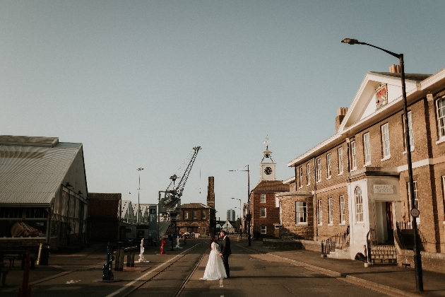 bride and groom standing in historic dockyard