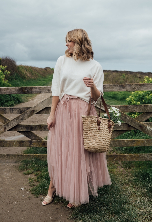 model in cream jumper and pink tulle skirt