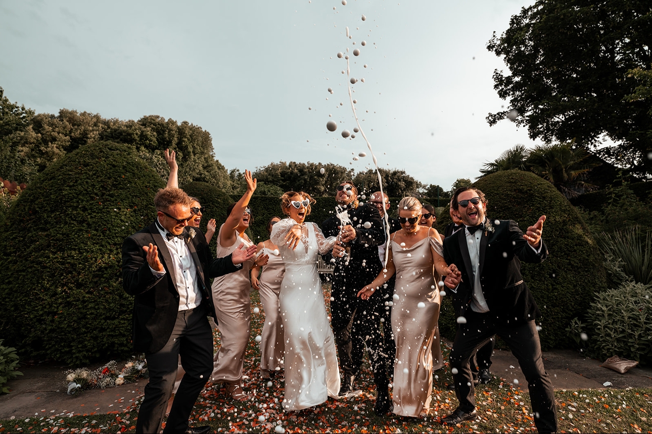 bridal party jumping in air