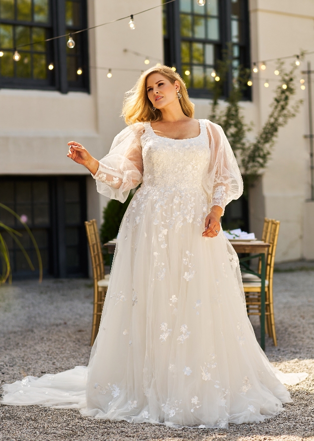 model in wedding dress with long sleeves