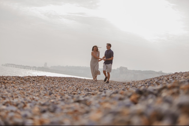 couple walking on stone beach