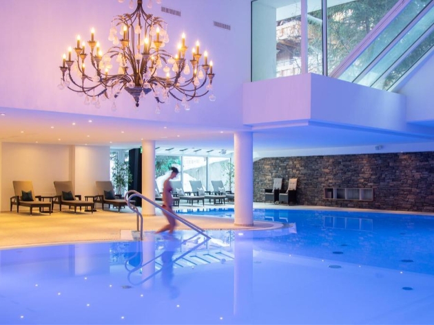 A woman getting into a swimming pool