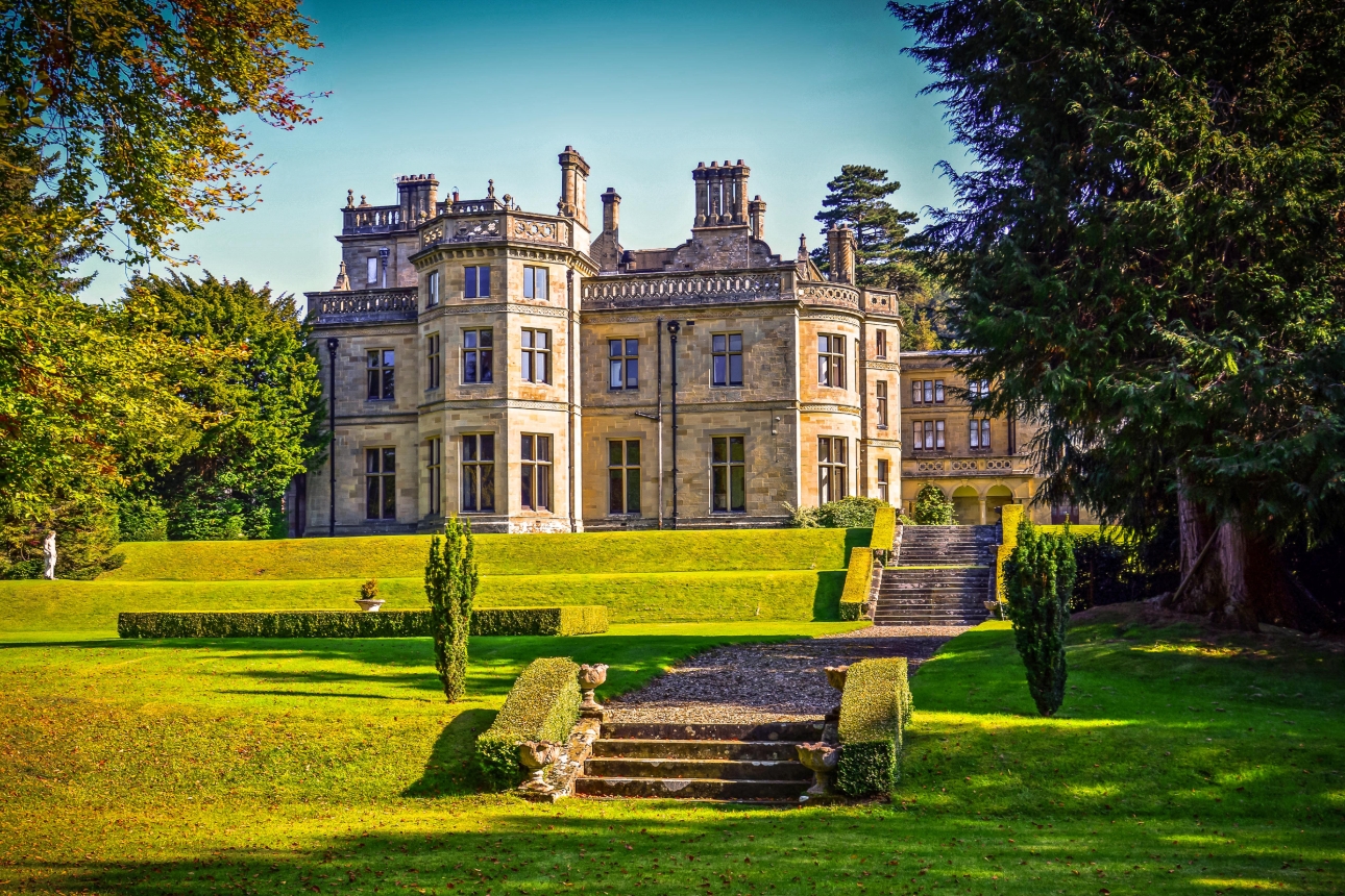 historic manor house at the end of a long grassed lawn