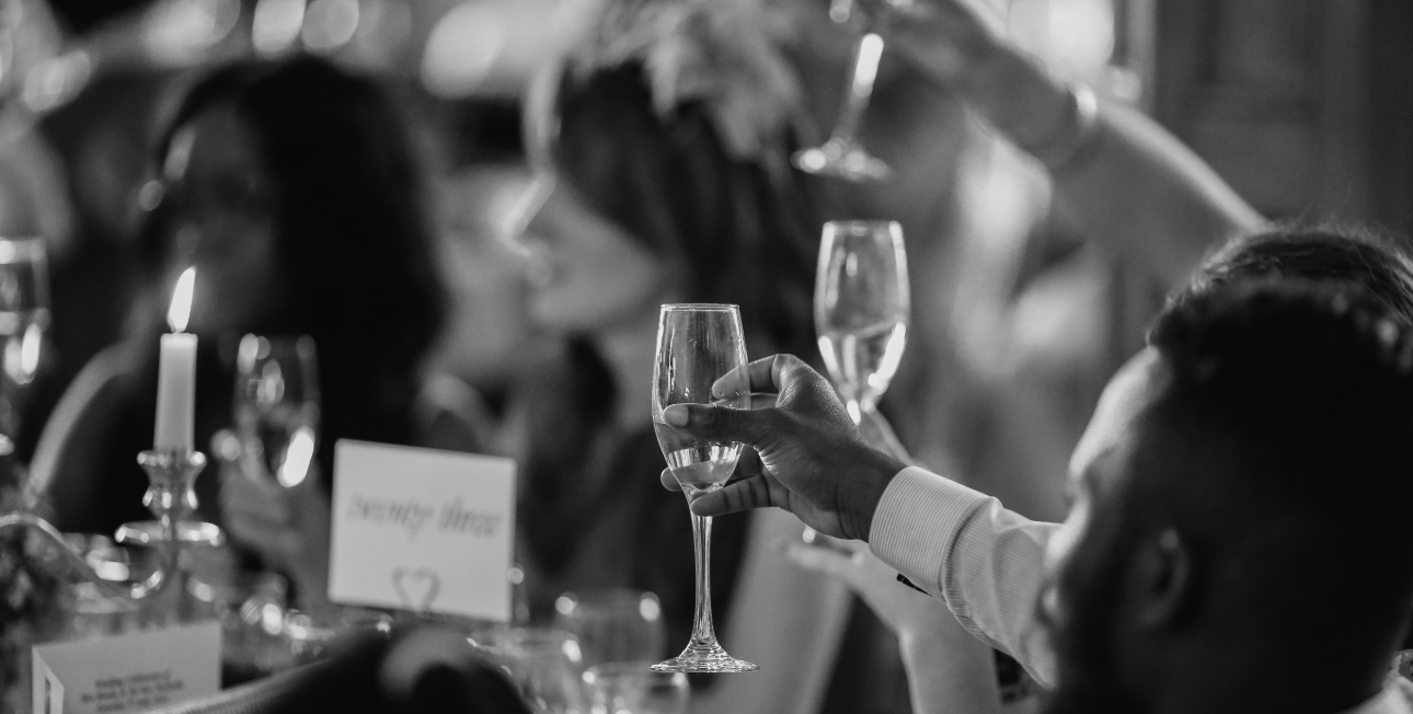 black and white image of people raising a toast