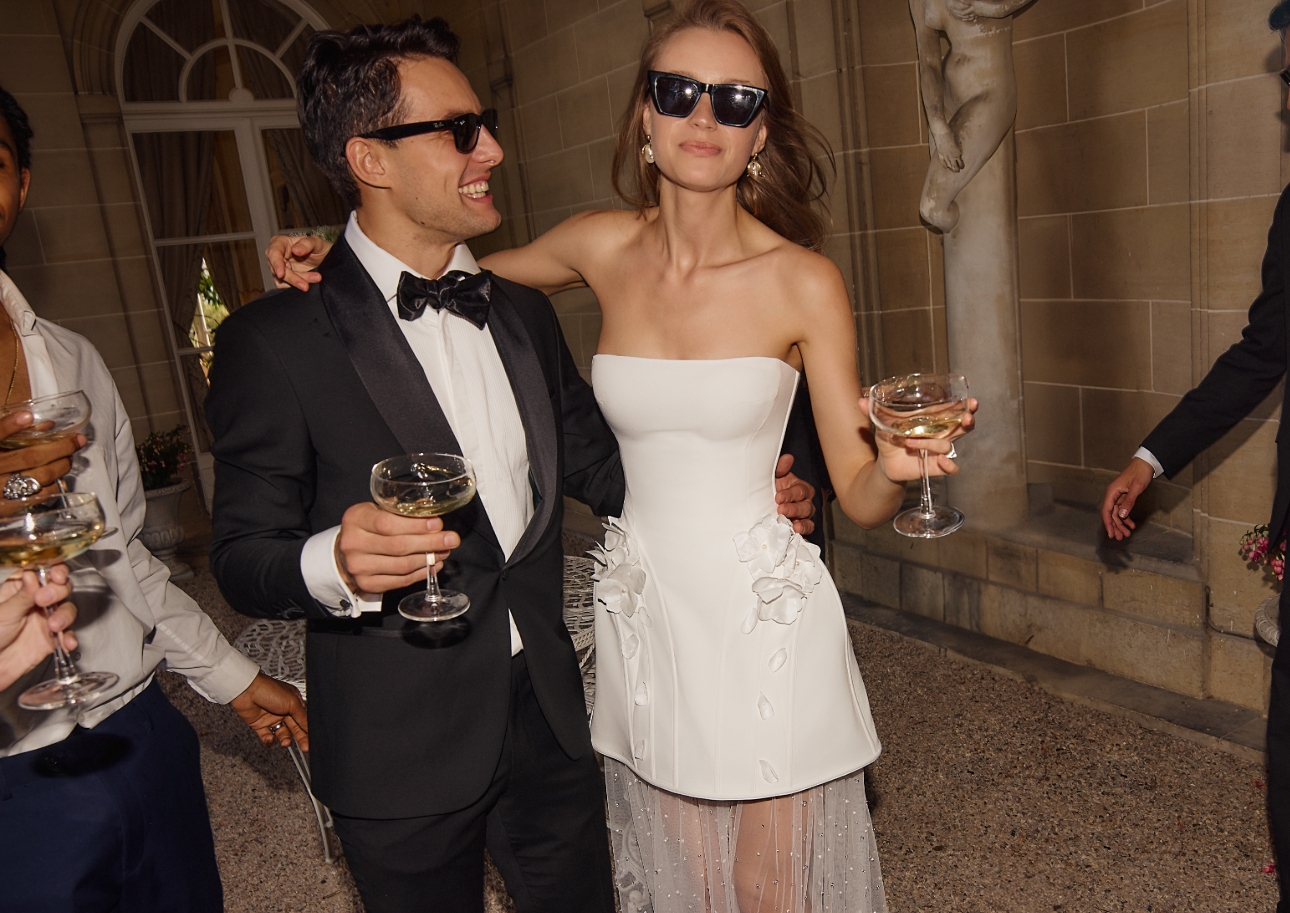 woman in short white dress holding drink