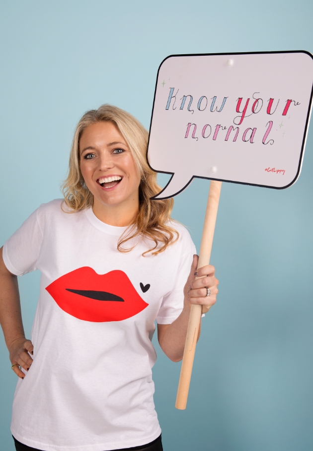 Blonde woman holding a sign that says