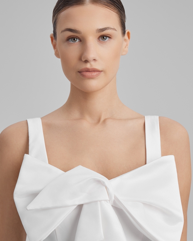 woman in white dress with big bow on the front