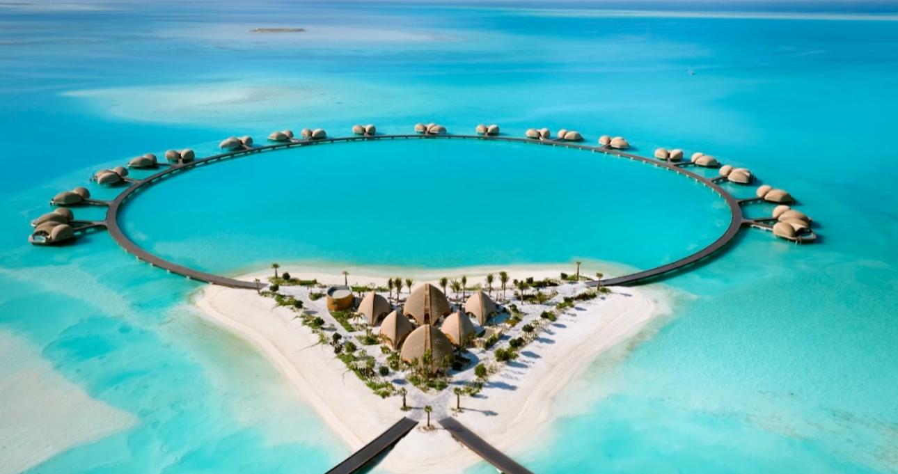 drone shot of huts over water 