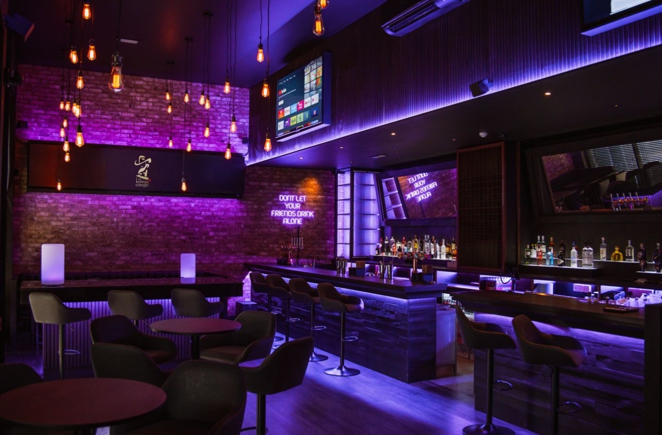 inside shot of dark bar with pink LED lights