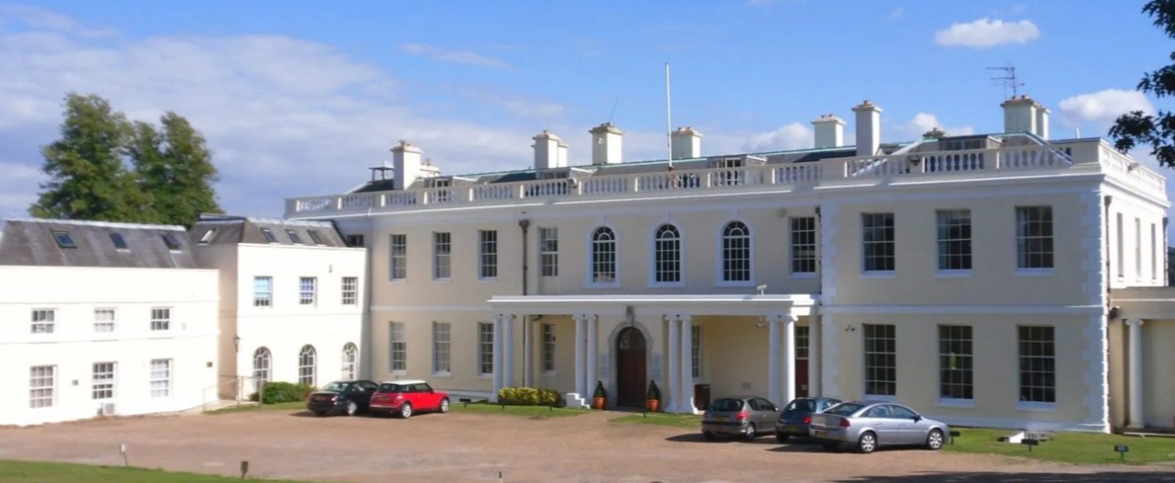 large white building with cars parked outside 