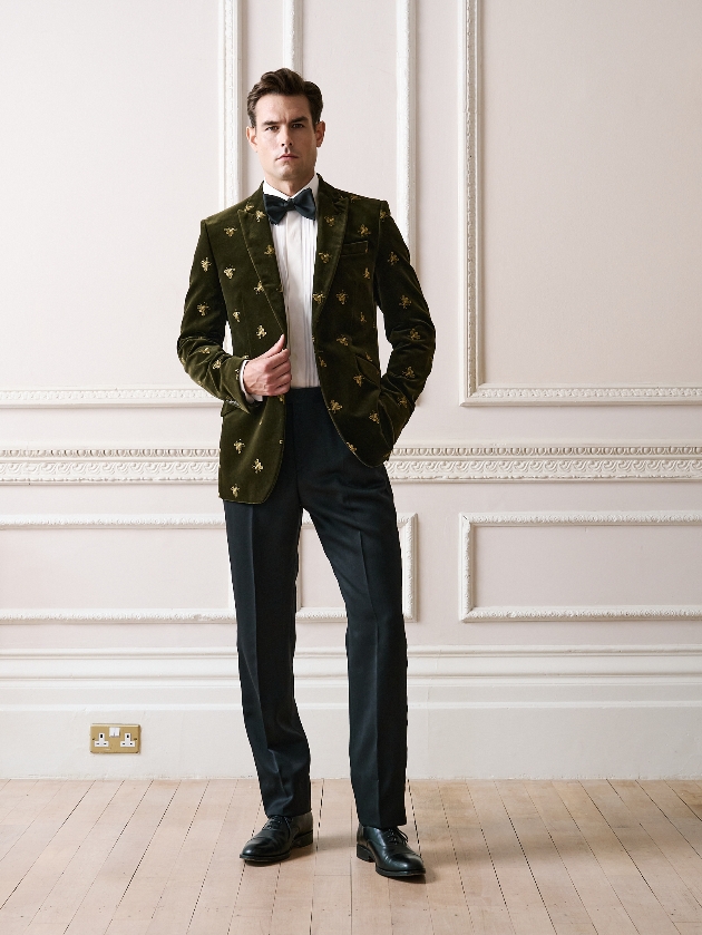 A man wearing a green velvet jacket