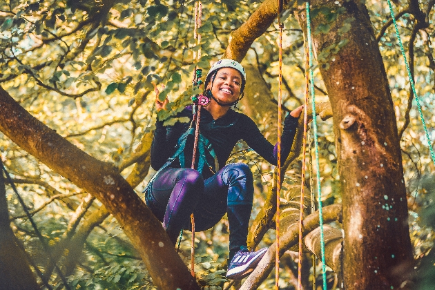 A woman climbing a tree