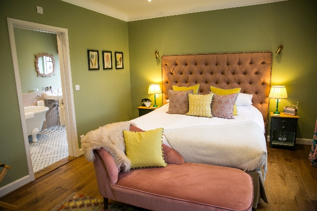 A bedroom decorated in green and pink