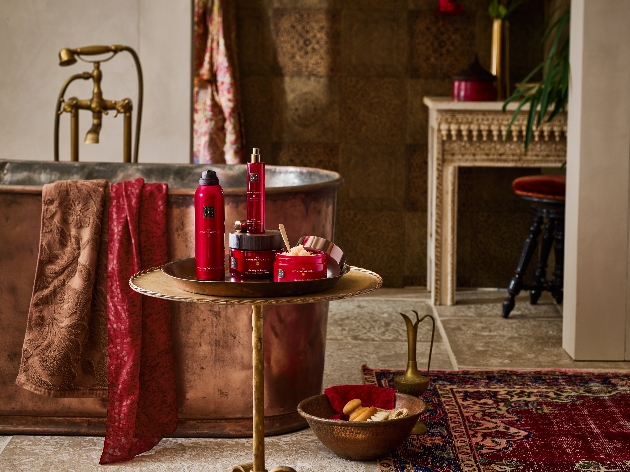 A bath with a table next to it with products on it